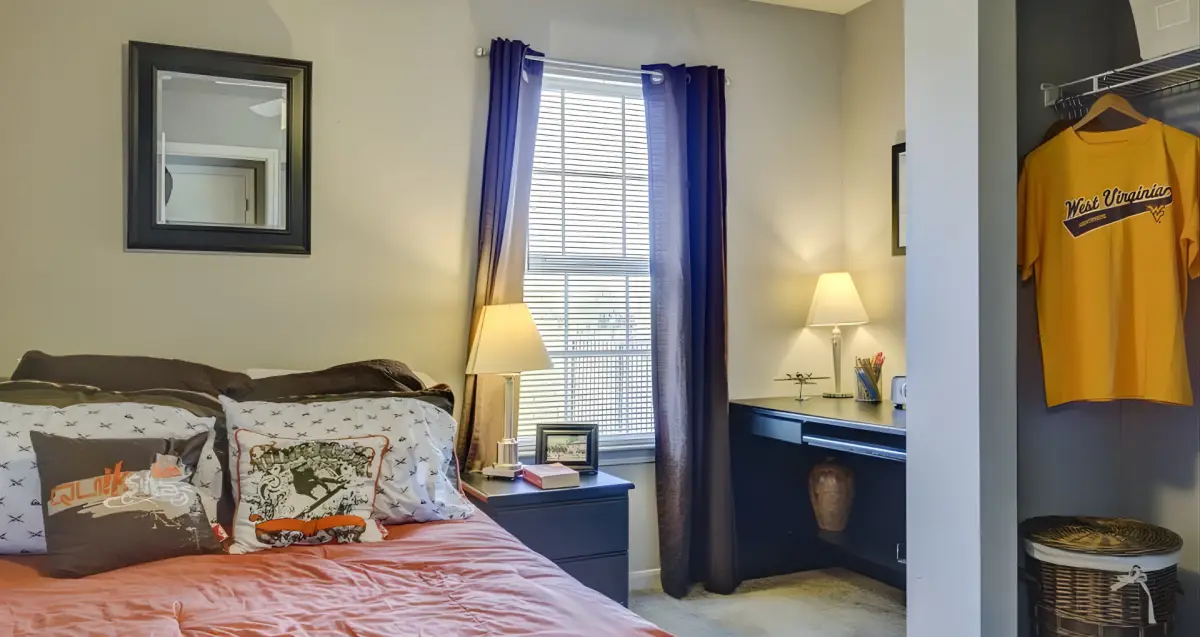 Spacious bedroom with desk and natural light at The Ridge apartments