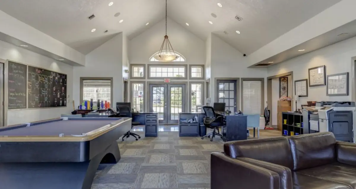 Resident lounge with workspace and pool table at The Ridge student apartments near WVU in Morgantown, WV.